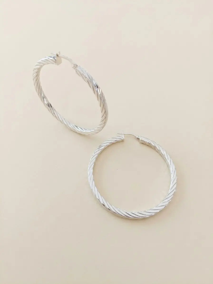 Orecchini a cerchio rigati OR0166 in argento 925 con motivo obliquo a spirale su fondo neutro, CICCO Gioielleria.