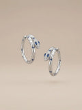 Orecchini a cerchio serpente in argento 925 con pietre blu OR0135 su sfondo neutro, CICCO Gioielleria.