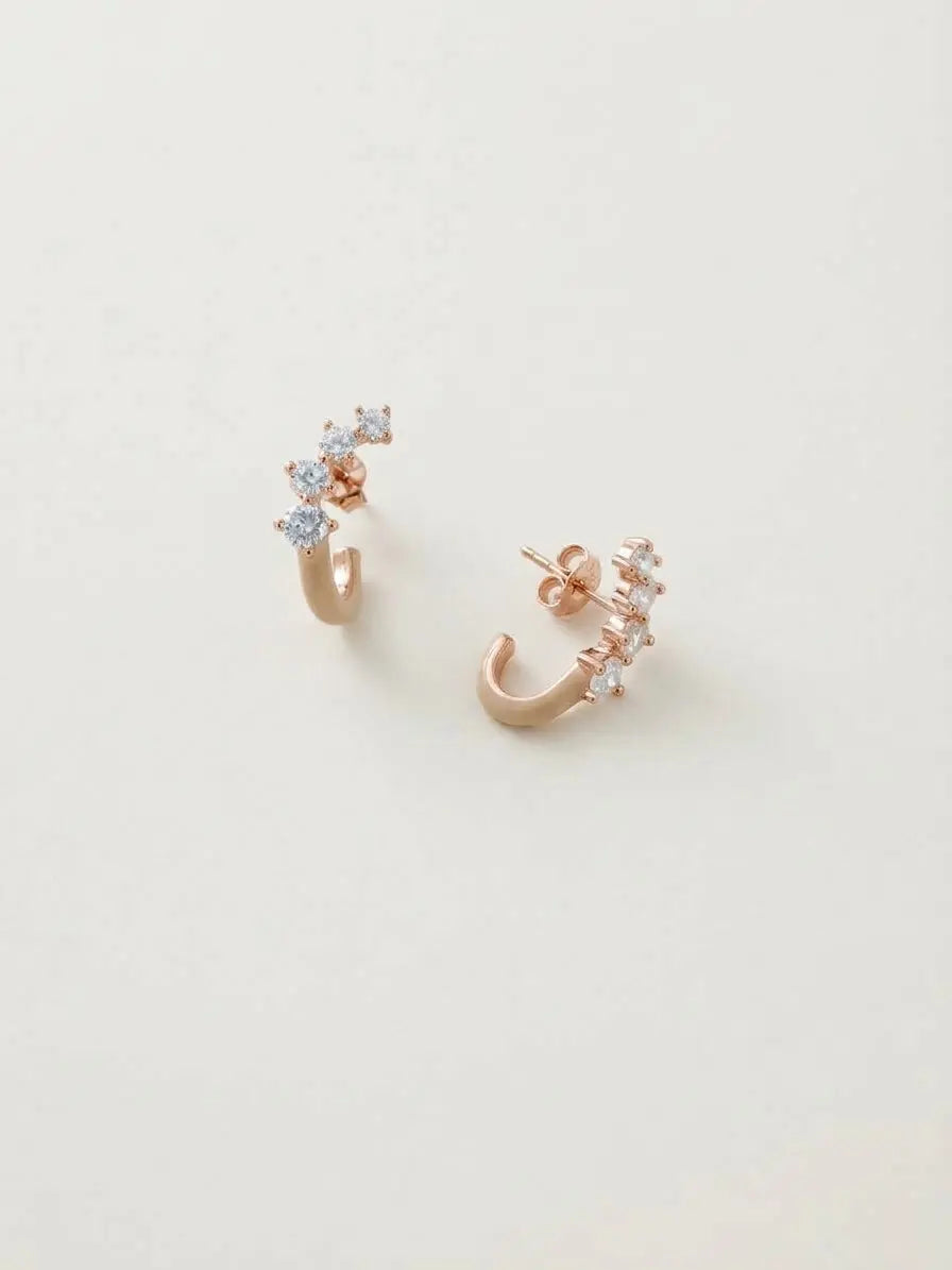 Orecchini OR0171 in argento 925 rosé con smalto beige e zirconi trasparenti su fondo chiaro, CICCO Gioielleria.